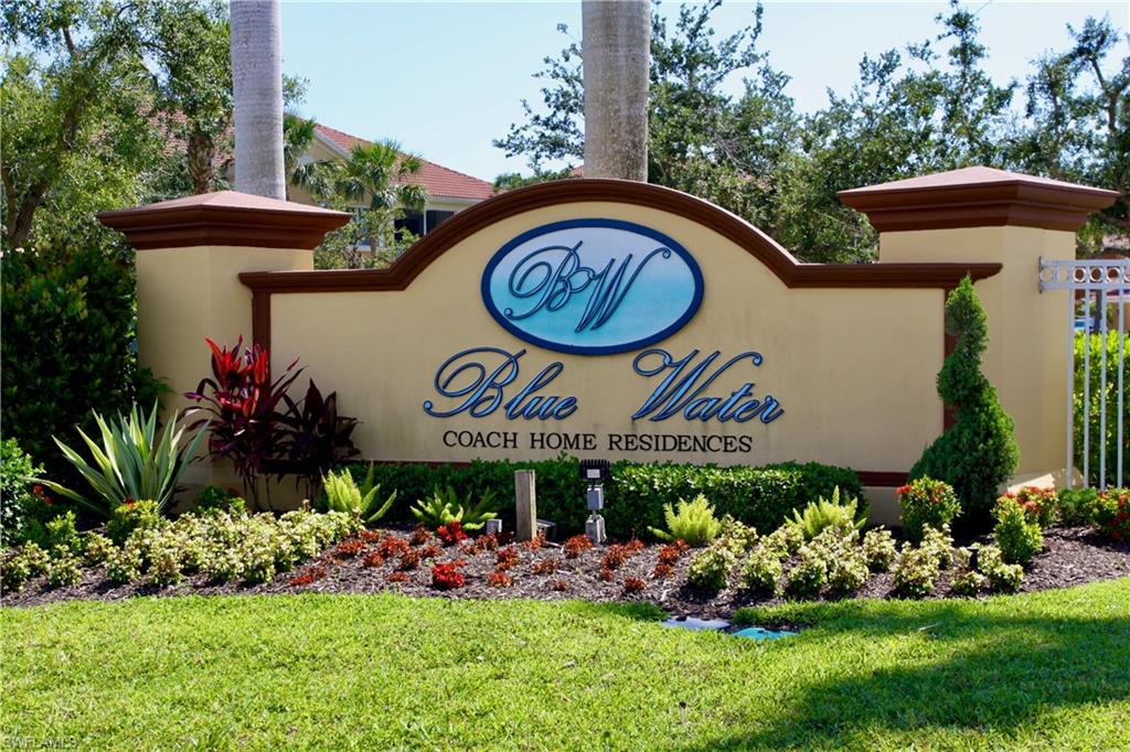 Community / neighborhood sign featuring a yard