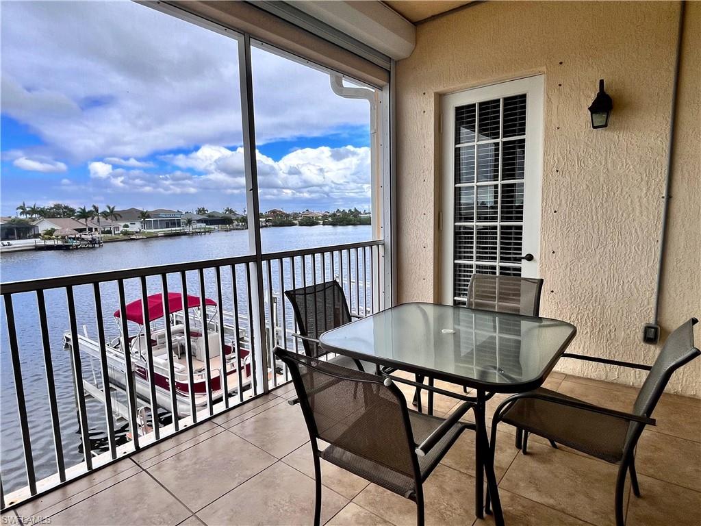 Step out onto the screened-in balcony and take in peaceful waterfront views of the boardwalk and passing boats. From this vantage point, you can watch boats coming and going along the canal, creating a relaxing coastal backdrop that changes throughout the day.
