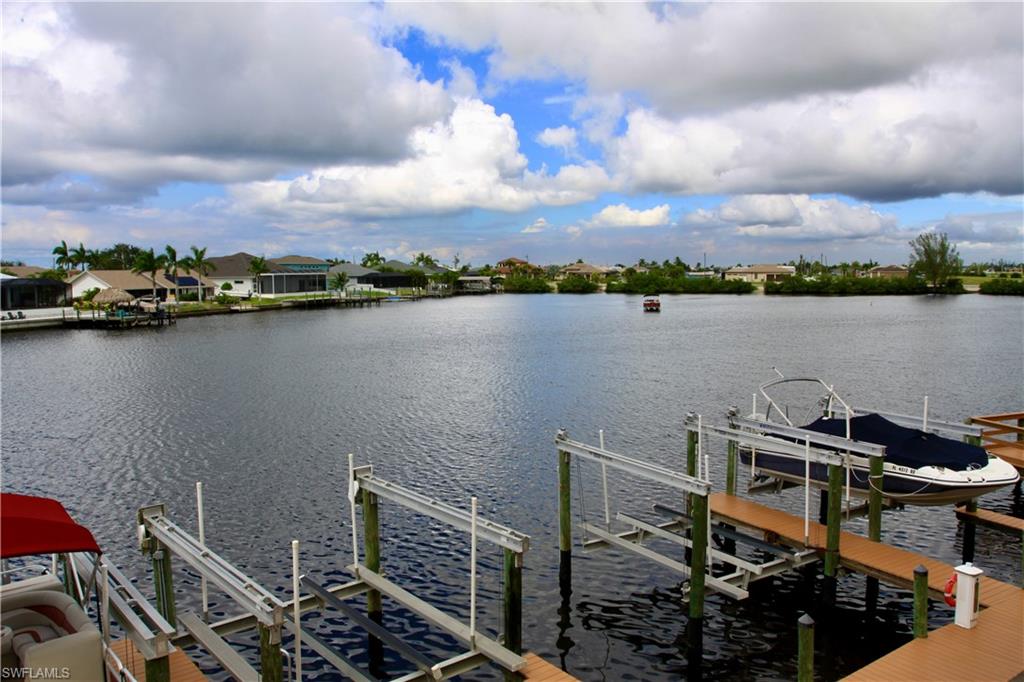 Dock area with boat lift and a water view