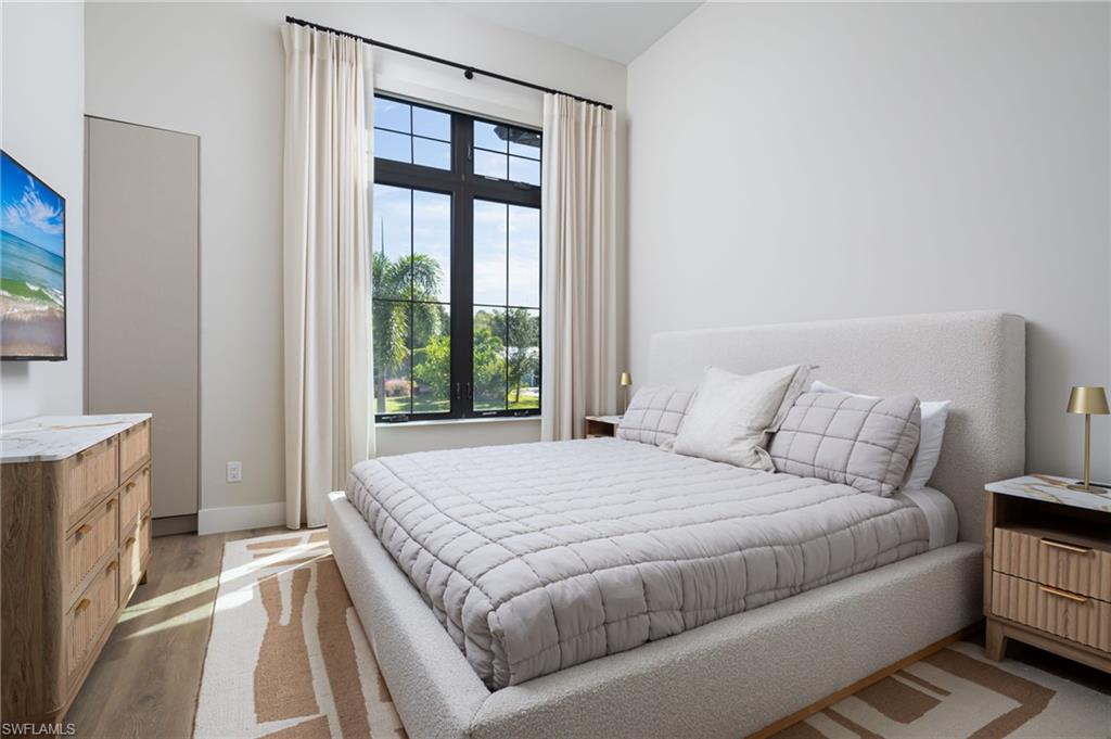 Bedroom with light wood-style floors and baseboards