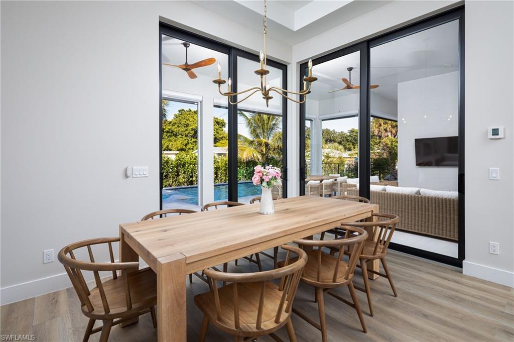 Dining area with a chandelier and light wood-style flooring