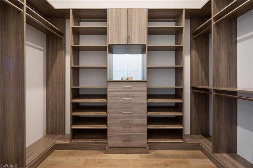 Walk in closet featuring light wood-style floors