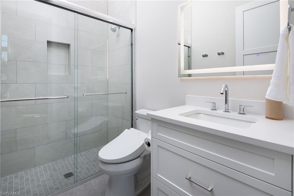 Bathroom with vanity and a shower stall