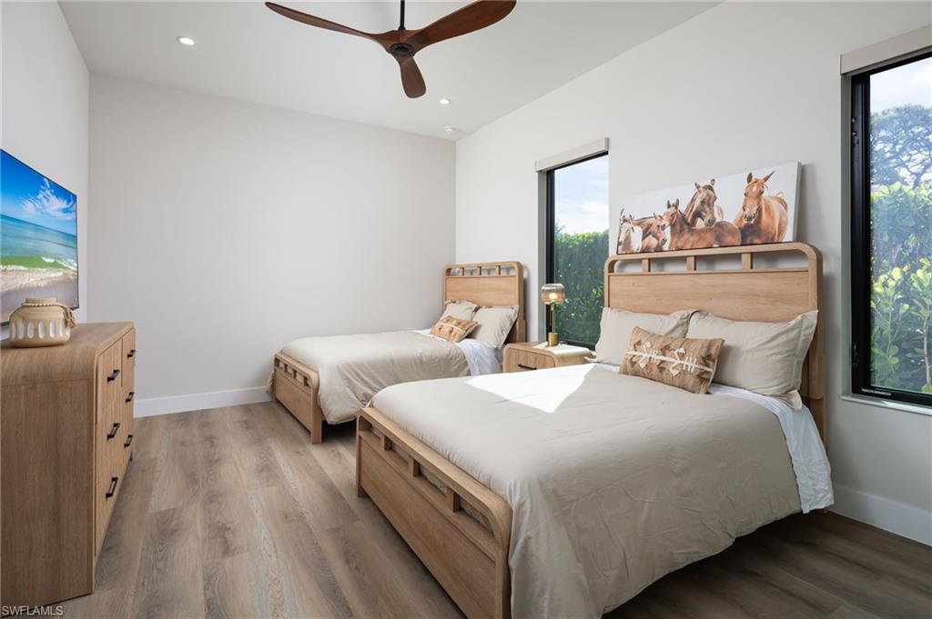 Bedroom with light wood finished floors, recessed lighting, and ceiling fan