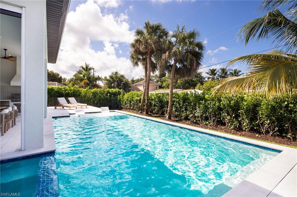 View of pool featuring a patio, exterior kitchen, and a ceiling fan