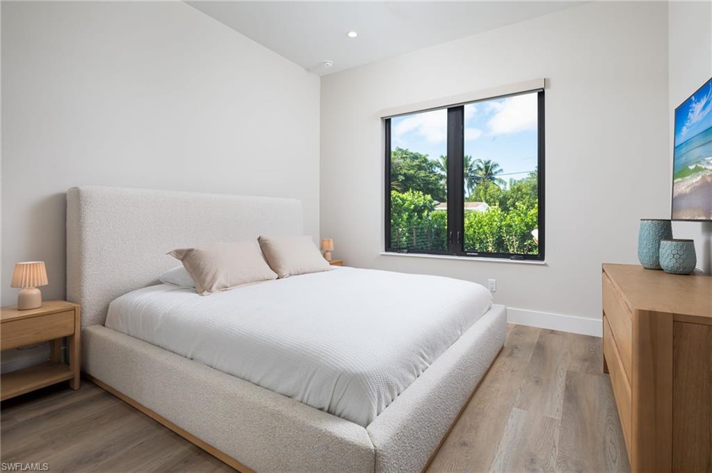 Bedroom with light wood-style flooring and recessed lighting