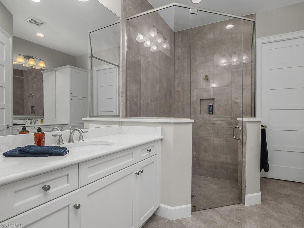 Master Bathroom with a large shower, dual vanities, and recessed lighting, frameless shower doors. Walk-in-Closet.