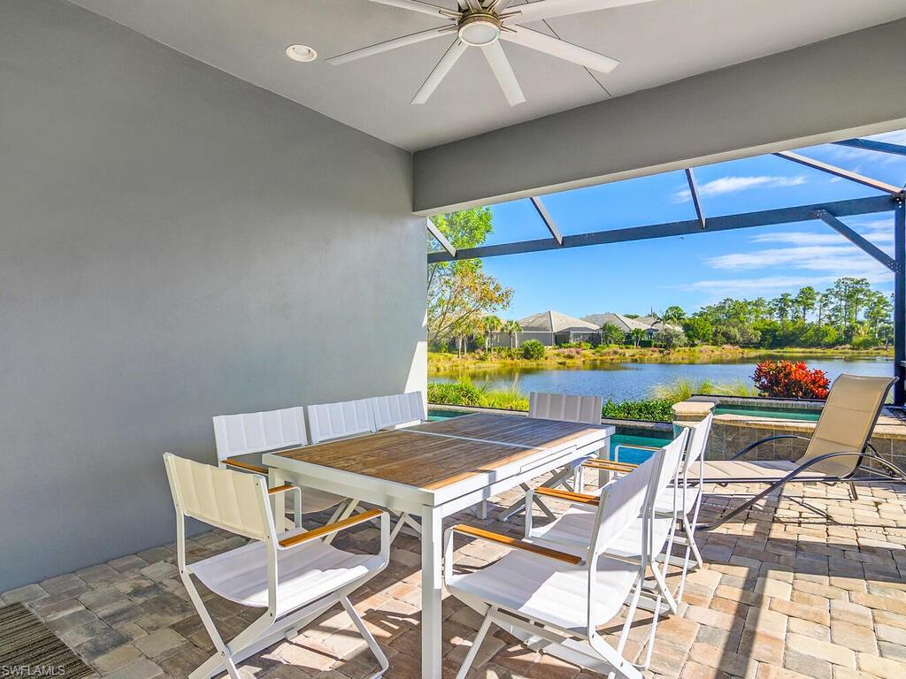 View of Outdoor Living,  featuring a dining area, a lanai, ceiling fan, a water view, Pool and Spa.