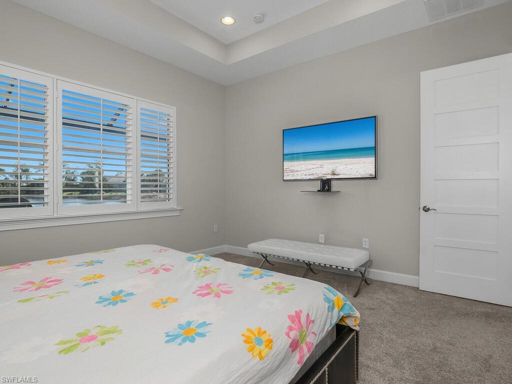 Master bedroom with a raised ceiling and recessed lighting, Eight foot shaker style doors throughout. Plantation Shutters.