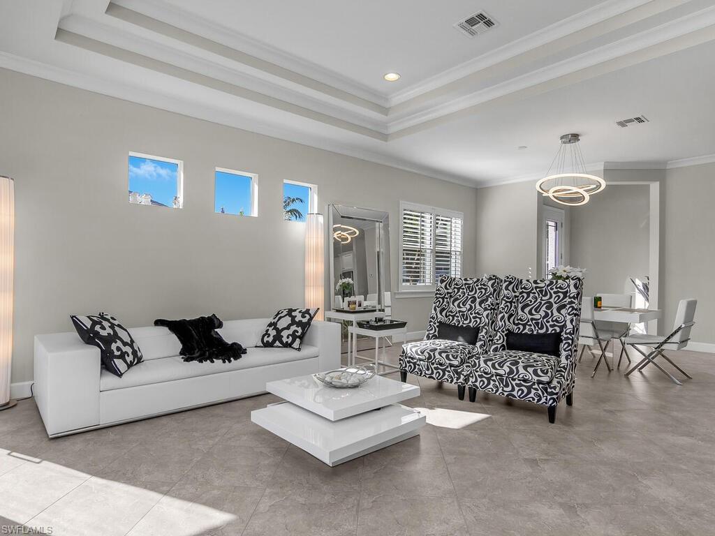 Living area with a tray ceiling, crown molding, and recessed lighting, Plantation Shutters, Entry.