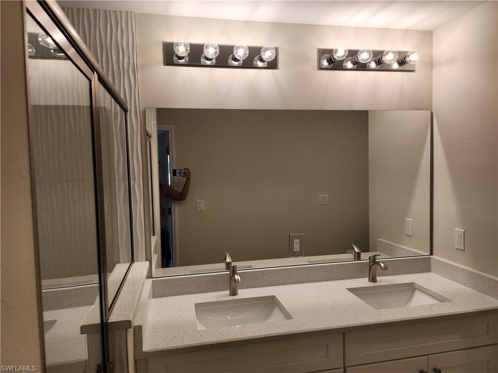 Bathroom with a stall shower and double vanity