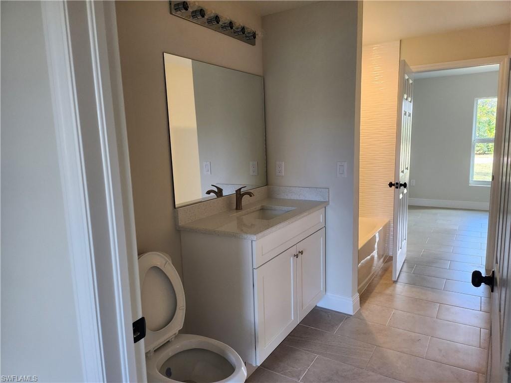 Bathroom with vanity and light tile patterned floors