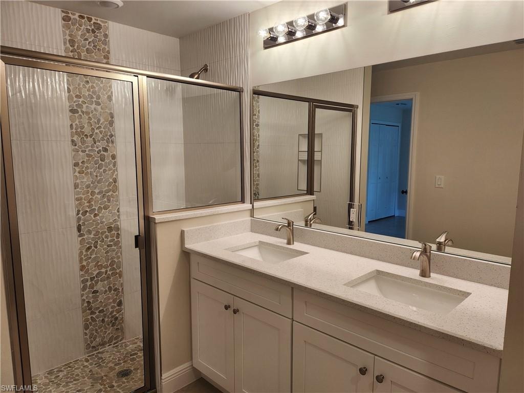 Bathroom with a stall shower and double vanity