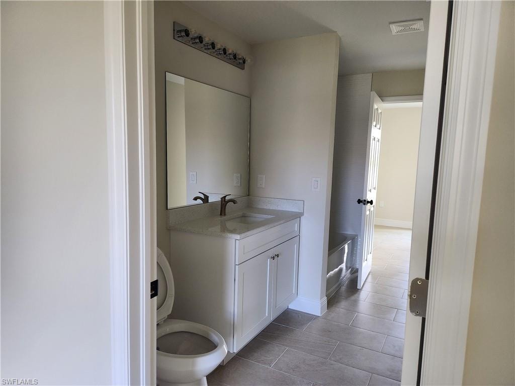 Bathroom with vanity and light tile patterned floors