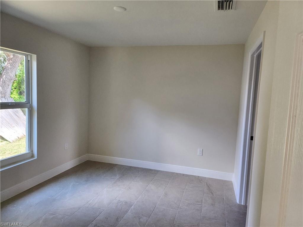 Empty room featuring baseboards