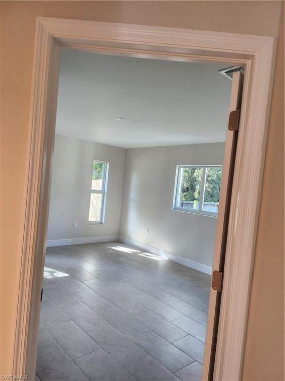 Tiled spare room with baseboards