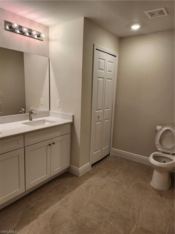 Bathroom featuring a closet, double vanity, and recessed lighting