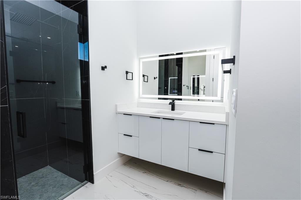 Walk in closet featuring light marble finish floors