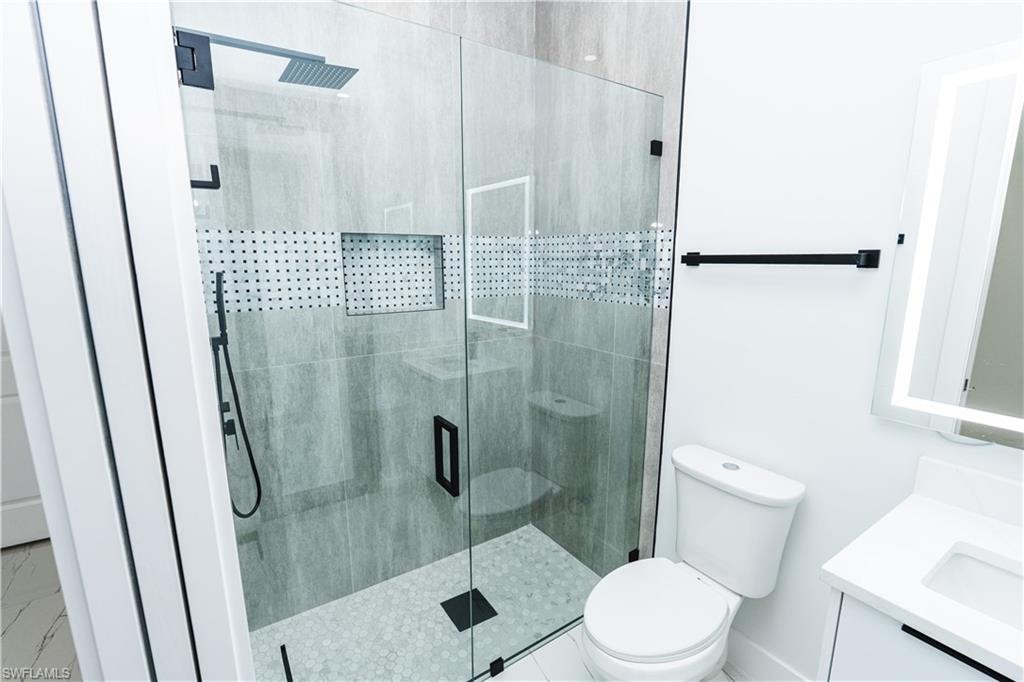 Half bathroom with vanity and light marble finish flooring