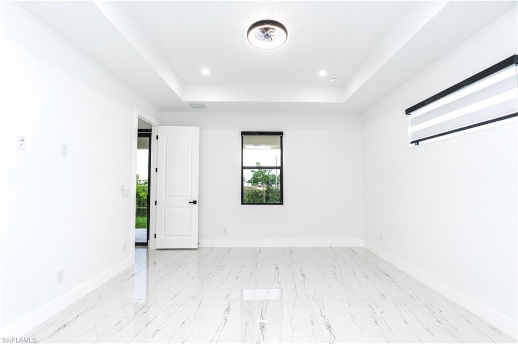 Full bathroom featuring vanity, a shower stall, and light marble finish flooring