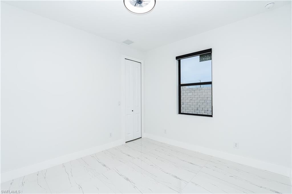 Half bath featuring vanity and light marble finish flooring