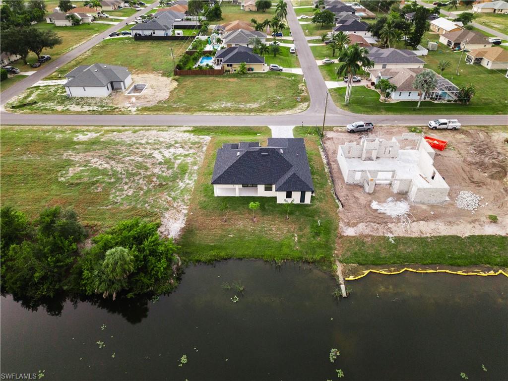 Aerial view of residential area featuring a nearby body of water