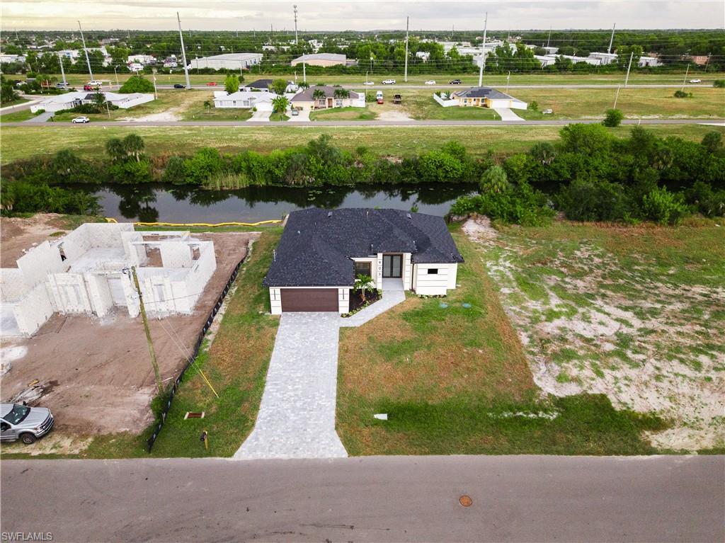 Aerial perspective of suburban area with a nearby body of water