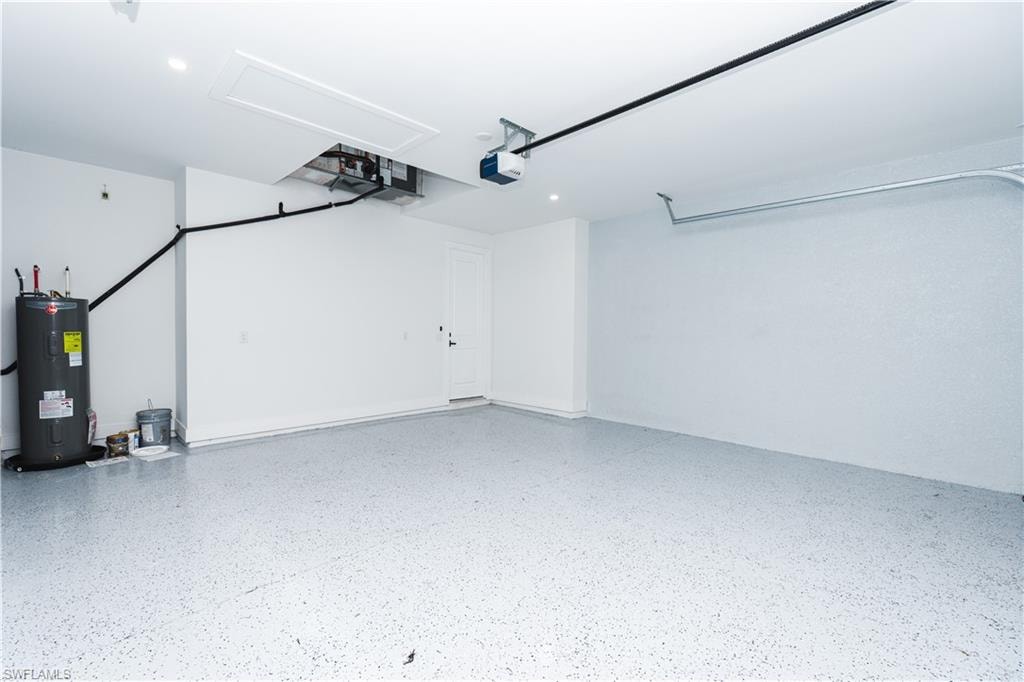 Garage with electric panel and a garage door opener