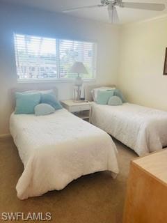 Carpeted bedroom featuring ceiling fan