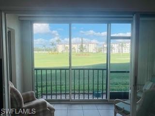 Doorway featuring golf course view and tile patterned floors