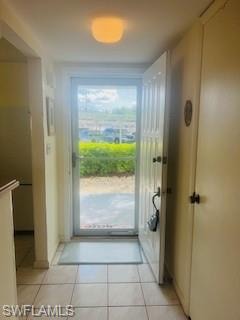 Doorway to outside with tile patterned floors