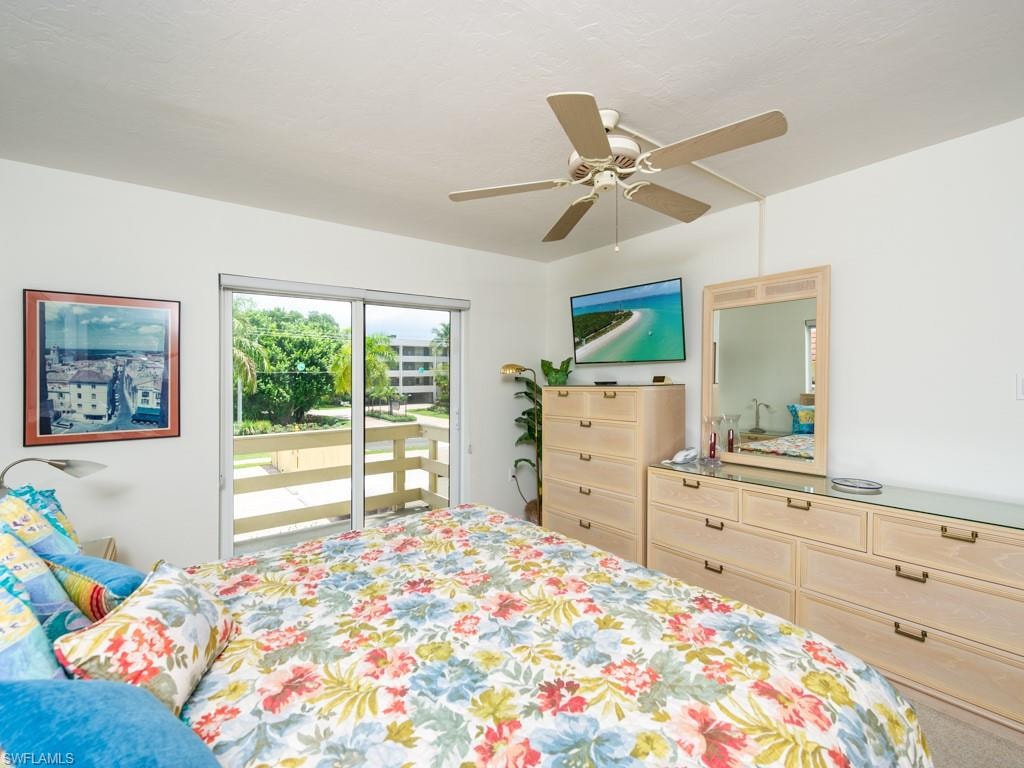 Bedroom with access to exterior and a ceiling fan