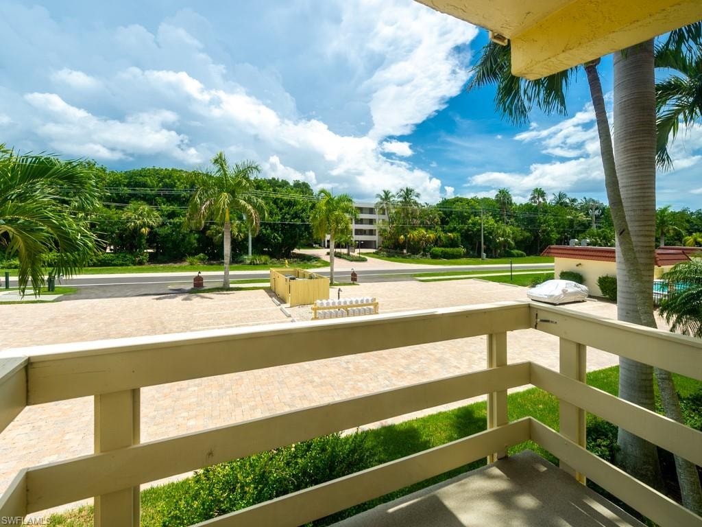 Balcony featuring view of wooded area