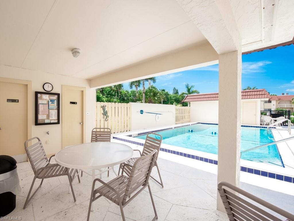 Community pool with a patio and outdoor dining space