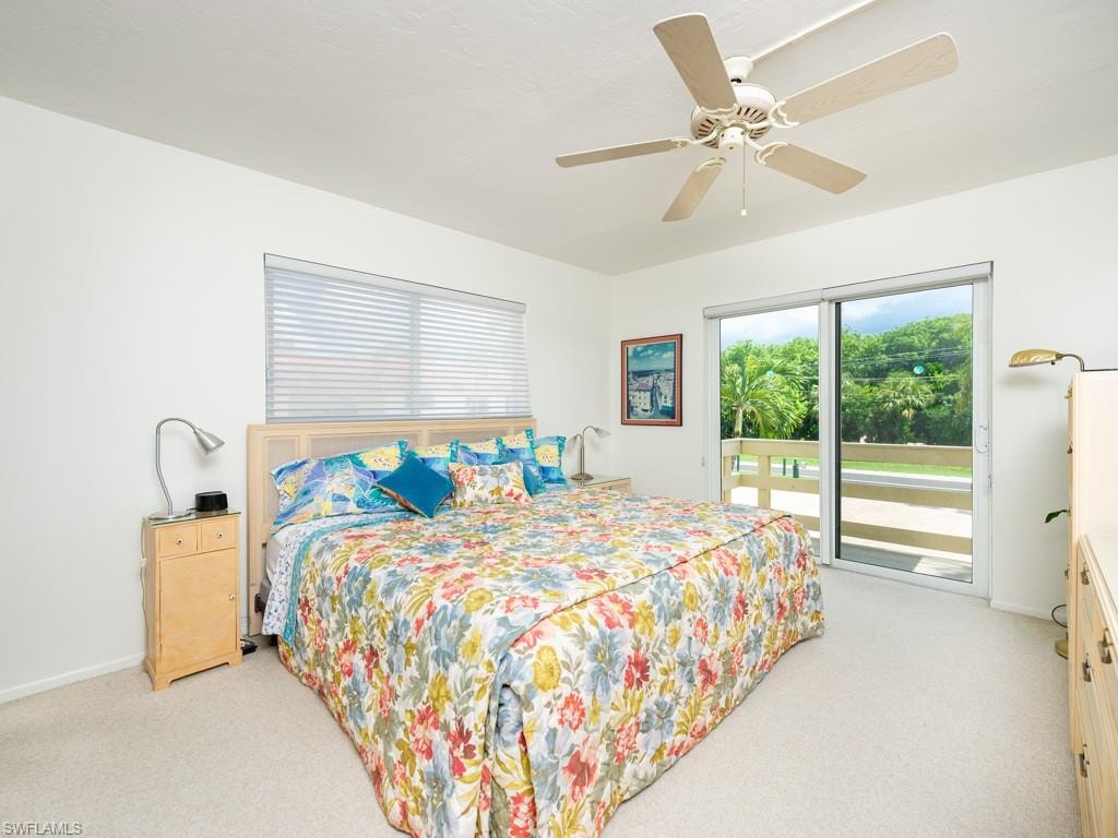 Bedroom featuring access to exterior, light carpet, and ceiling fan