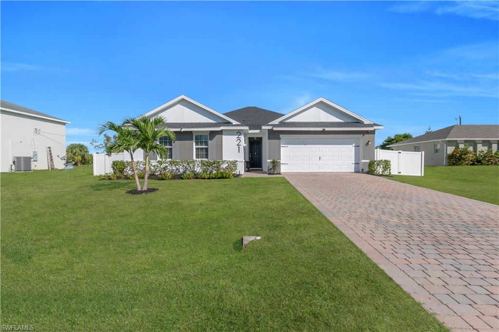 Single story home featuring decorative driveway, an attached garage, and stucco siding