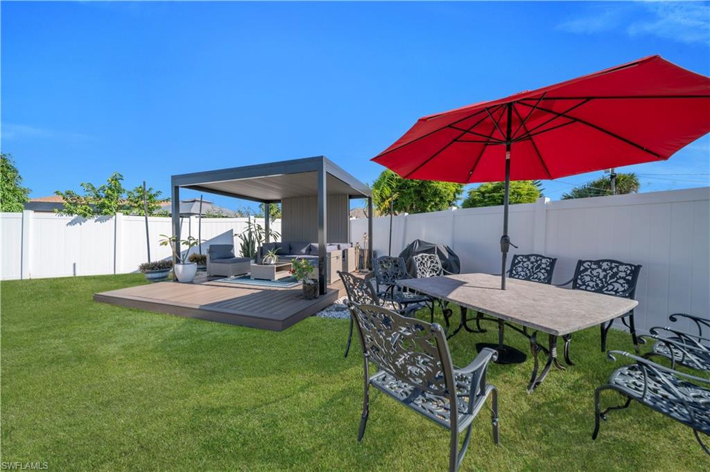 Fenced backyard with a patio and a hot tub