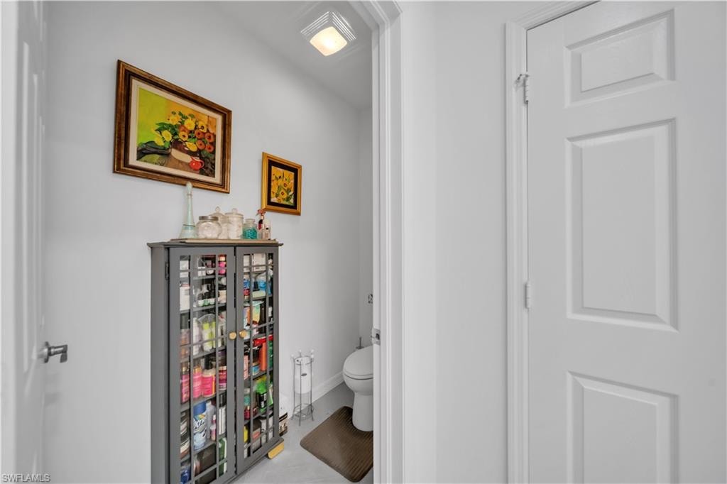 Washroom with cabinet space, light tile patterned floors, and independent washer and dryer