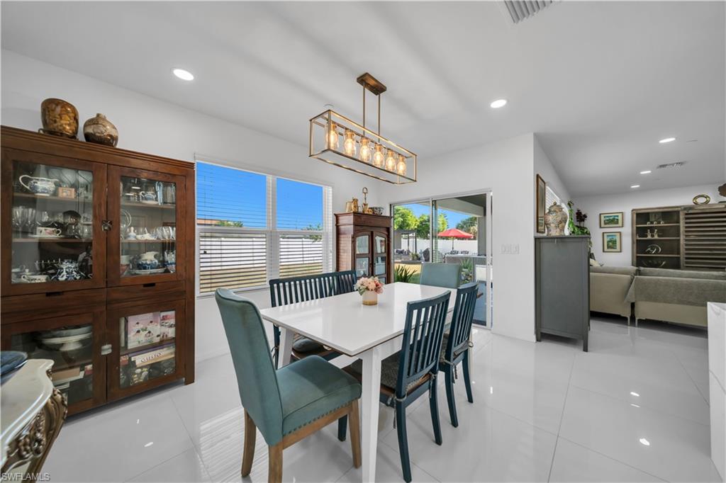 Dining space featuring a chandelier, recessed lighting, and light tile patterned flooring