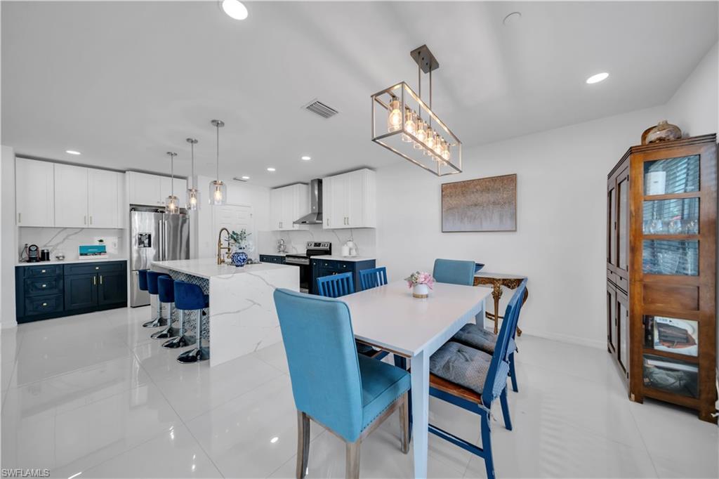 Dining room with recessed lighting and light tile patterned flooring