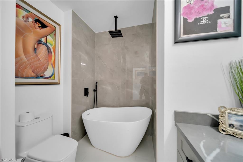 Bathroom with toilet and light tile patterned floors
