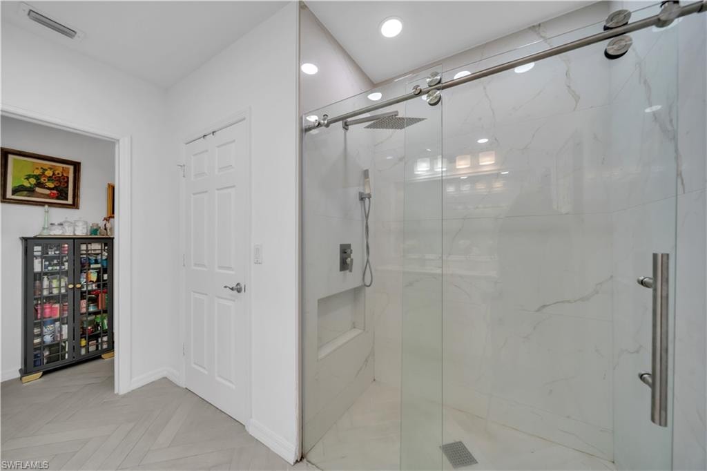 Corridor with light tile patterned flooring, a desk, and recessed lighting