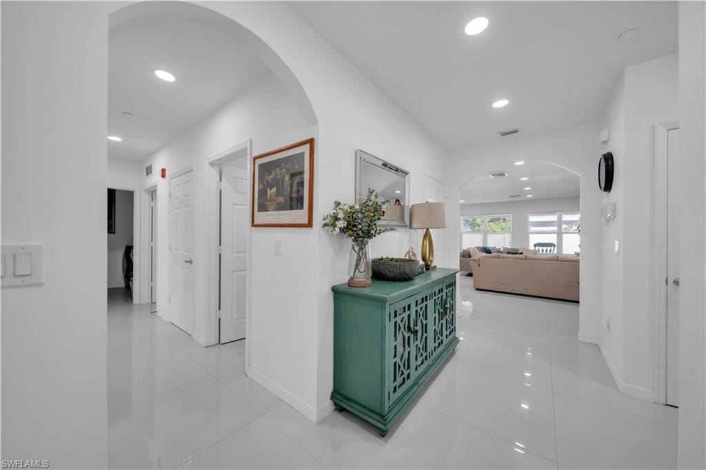 Hall with recessed lighting and light tile patterned floors