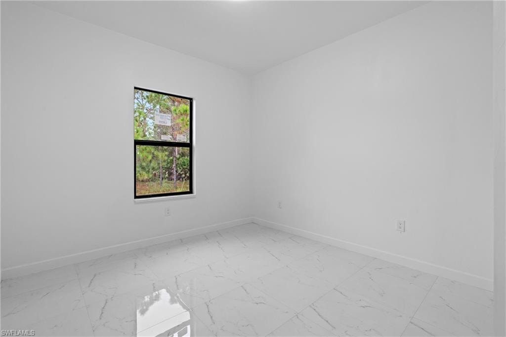 Empty room with light marble finish floors and baseboards