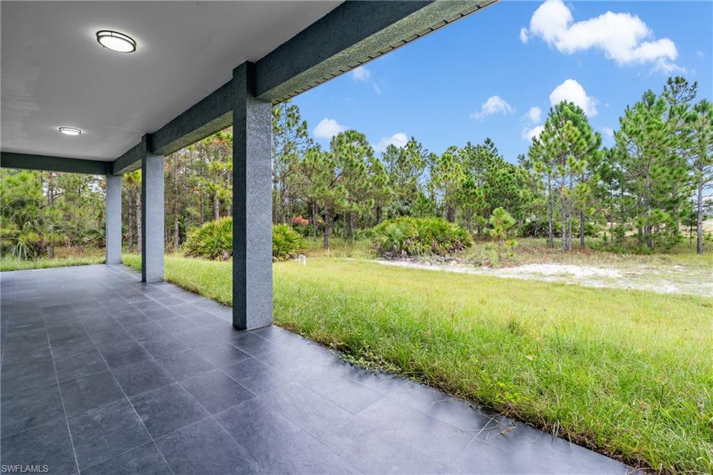 View of patio / terrace featuring view of wooded area