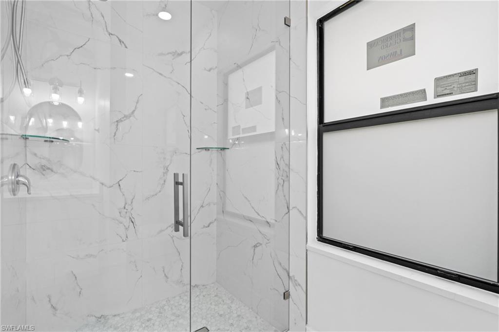 Full bathroom with a marble finish shower