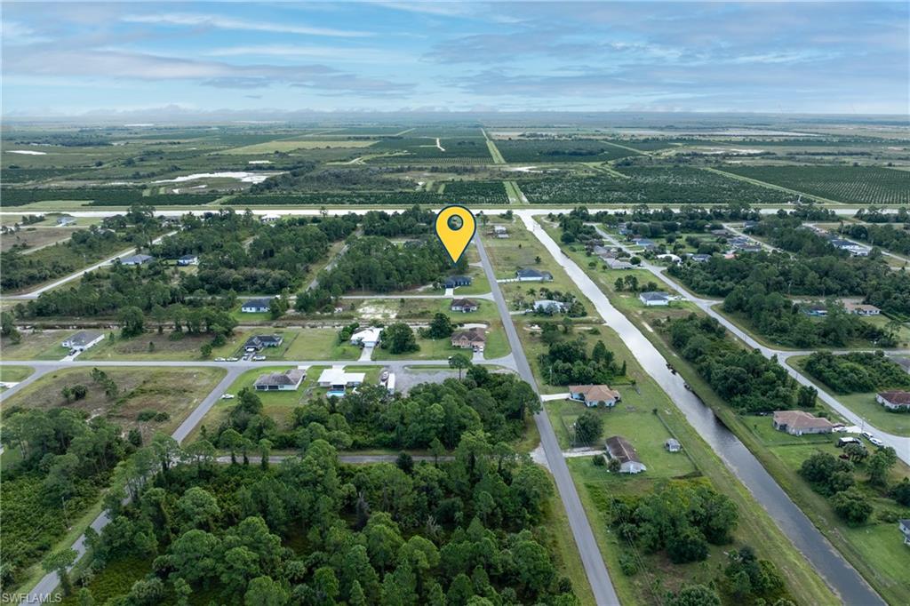 View of property location with a tree filled landscape