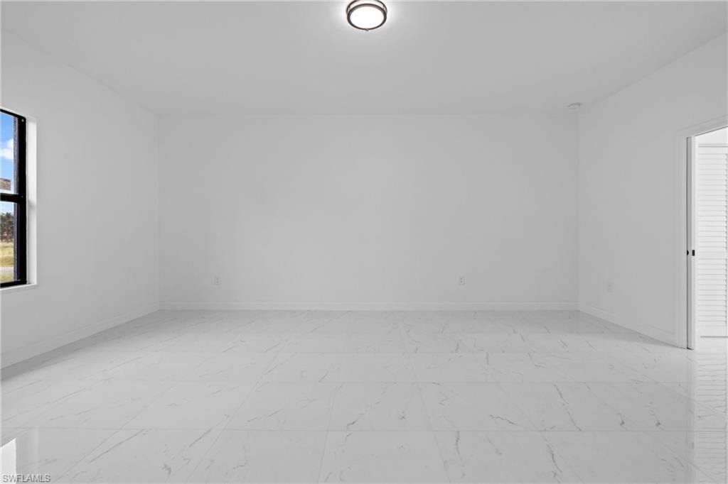 Unfurnished room featuring baseboards