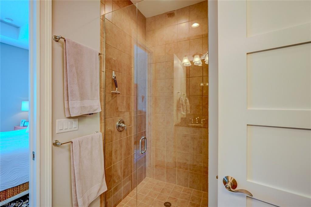 Full bath featuring ensuite bathroom and a shower stall