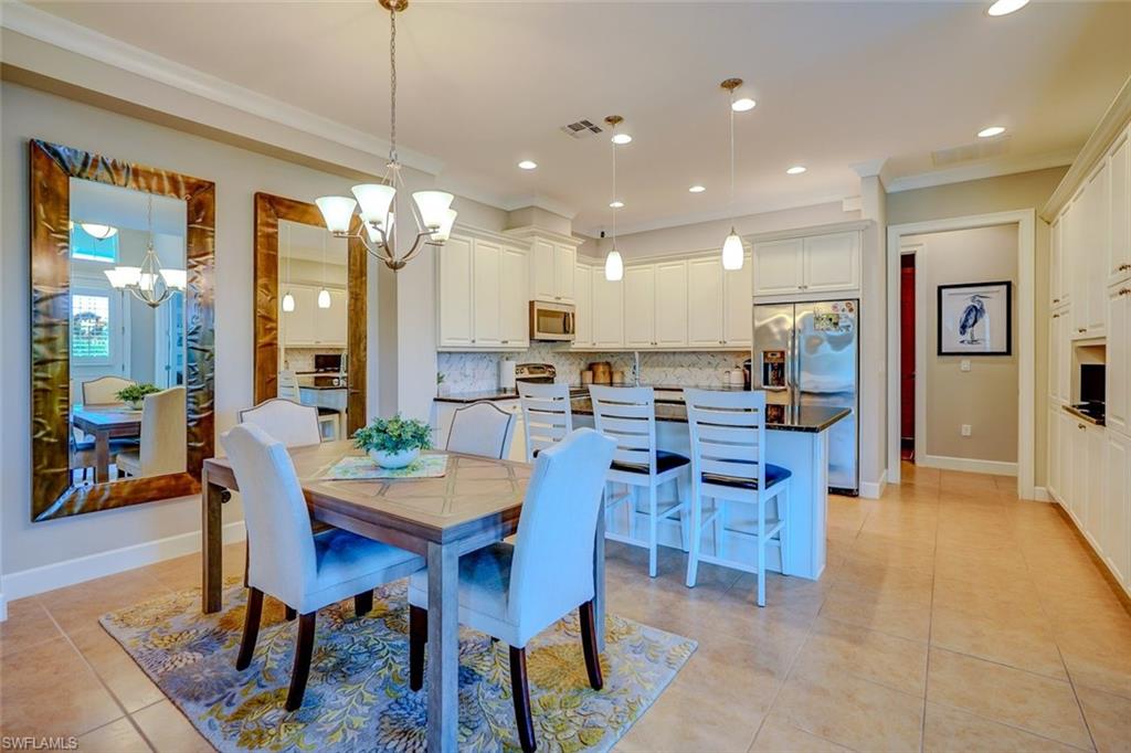 Dining area featuring ornamental molding, light tile patterned floors, a chandelier, and recessed lighting